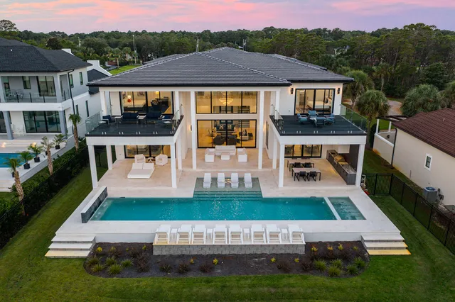 a view of house with garden space and car parked