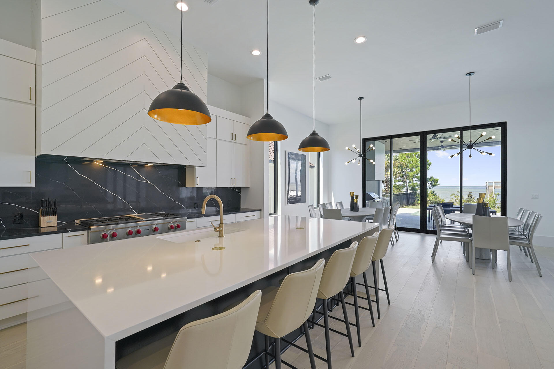 396 Walton Way Miramar Beach, FL 32550 - Photo 16 of 75 a kitchen with stainless steel appliances a dining table chairs sink and wooden floor