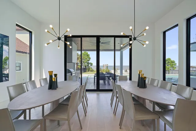 a view of house with a big yard and potted plants