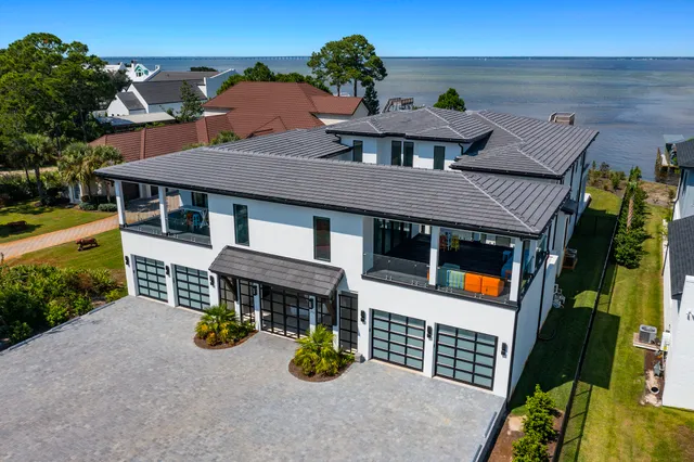 an aerial view of a house with swimming pool and patio