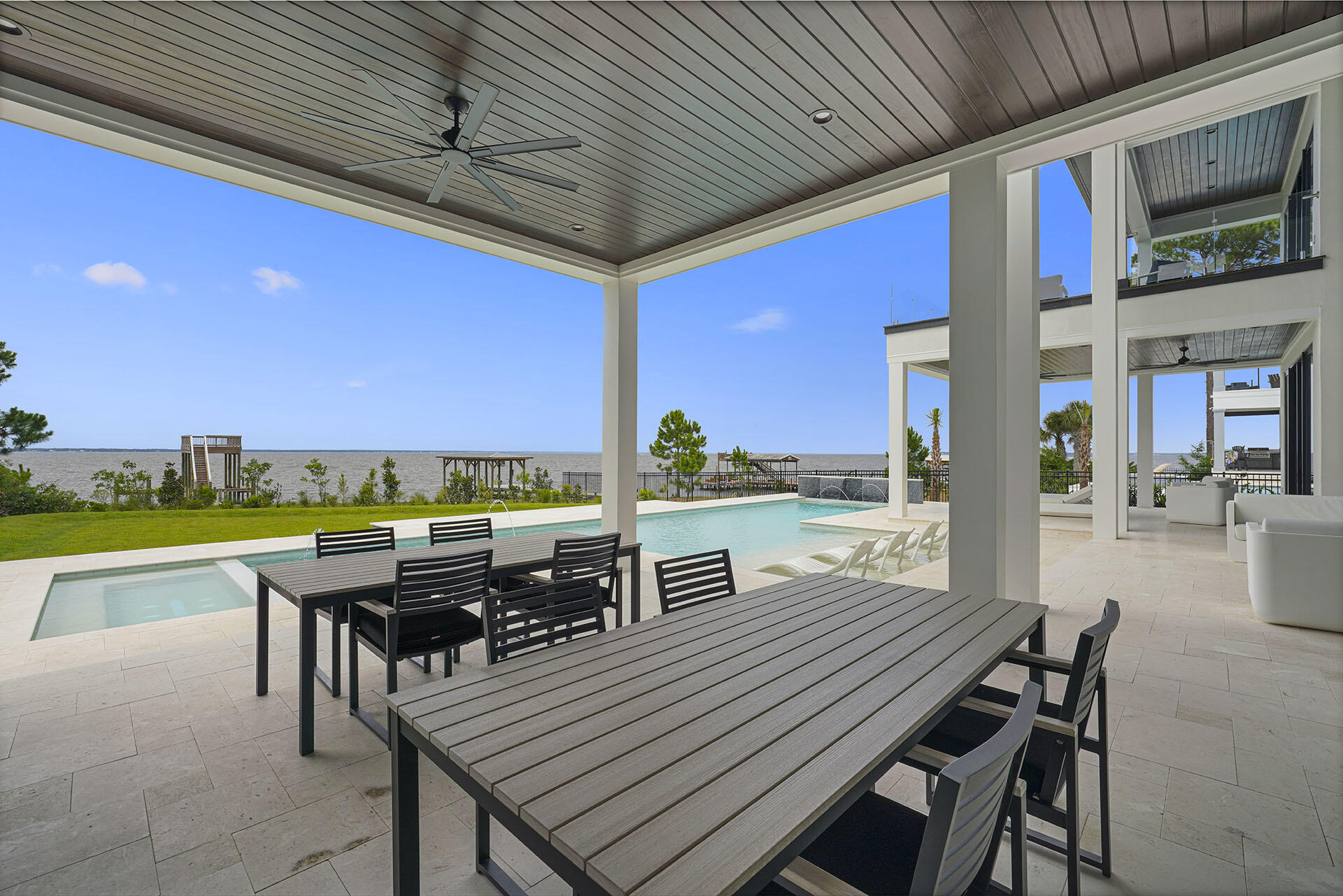 396 Walton Way Miramar Beach, FL 32550 - Photo 32 of 75 a view of a patio with table and chairs with wooden floor and fence