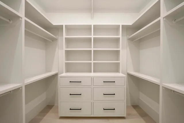 a bedroom with a large bed and a flat tv screen