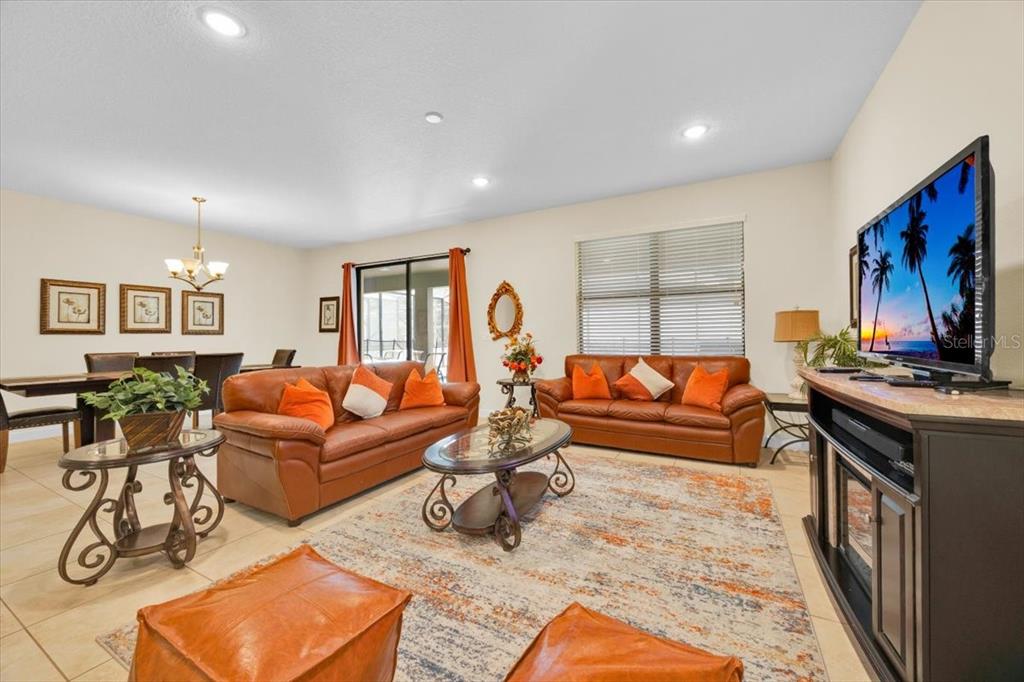 9032 Shadow Mountain Street Davenport, FL 33896 - Photo 15 of 43 a living room with furniture kitchen view and a window