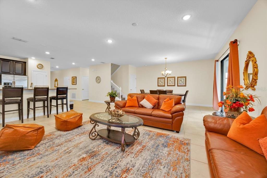 9032 Shadow Mountain Street Davenport, FL 33896 - Photo 16 of 43 a living room with furniture and a wooden floor
