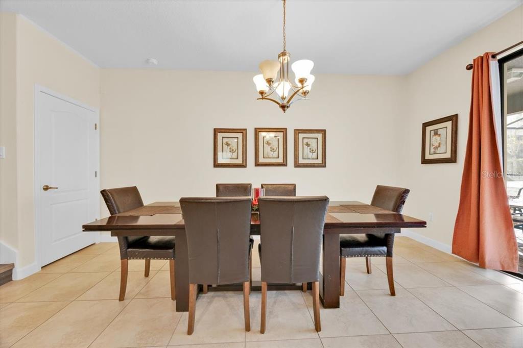 9032 Shadow Mountain Street Davenport, FL 33896 - Photo 17 of 43 a view of a dining room with furniture