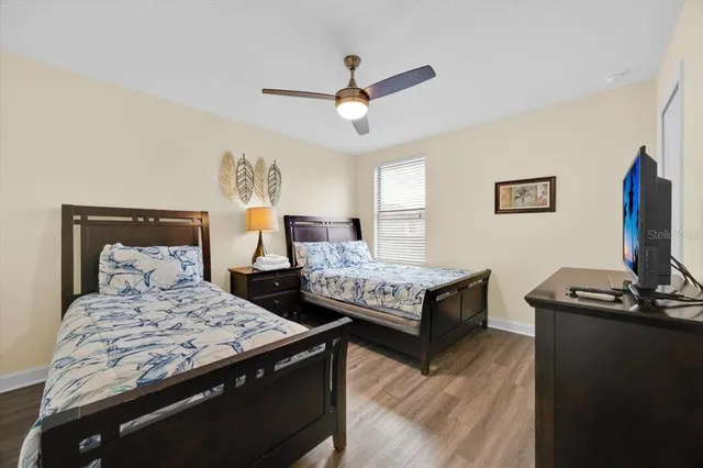 a bedroom with two beds and a desk