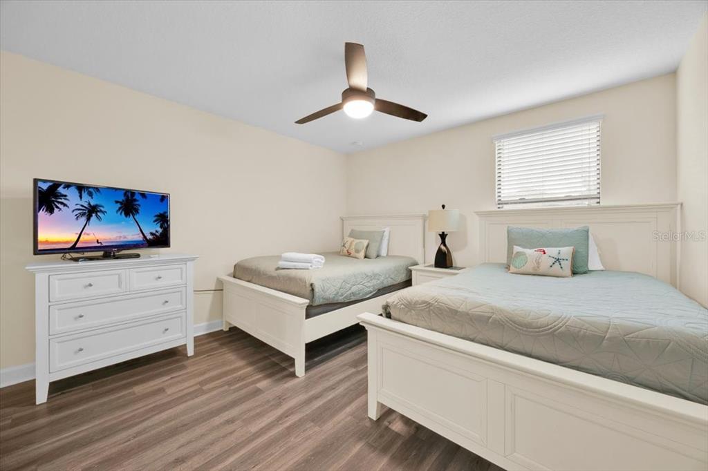 9032 Shadow Mountain Street Davenport, FL 33896 - Photo 22 of 43 a bedroom with a bed and a flat screen tv