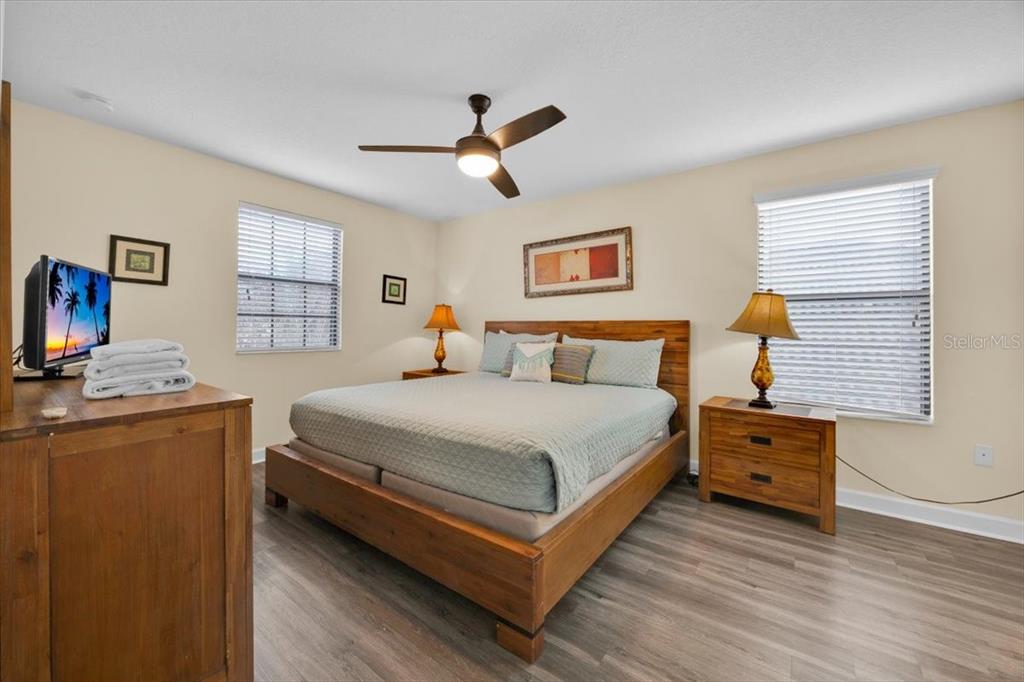 9032 Shadow Mountain Street Davenport, FL 33896 - Photo 28 of 43 a bedroom with a bed and wooden floor