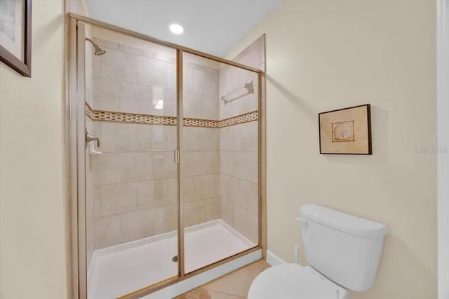 a bathroom with a shower a toilet and a shower