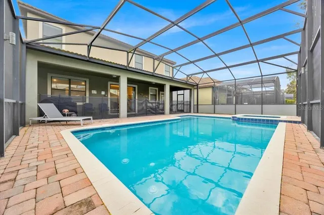 a view of swimming pool with a lounge chairs