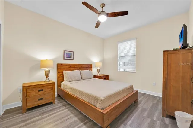 a bedroom with a bed and a flat tv screen on dresser