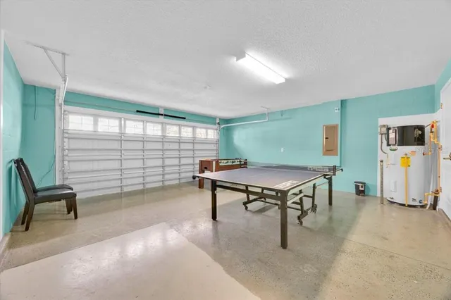 a living room with furniture a table and large windows