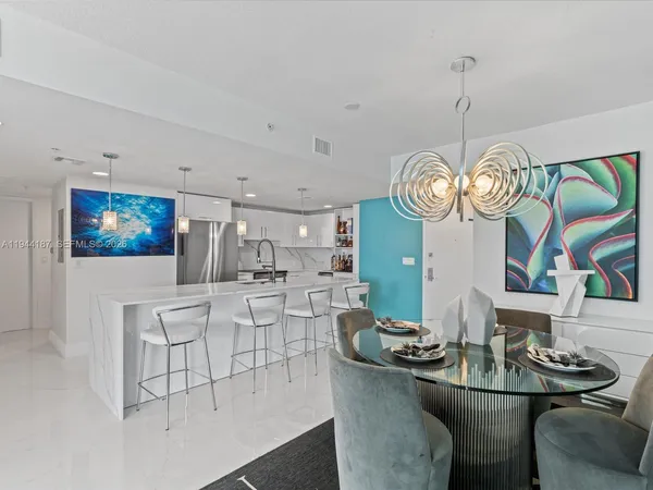a large kitchen with a table and chairs