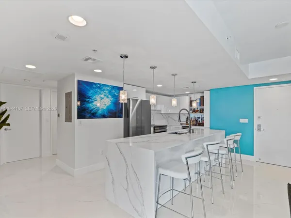 a view of a kitchen with furniture and a ceiling fan