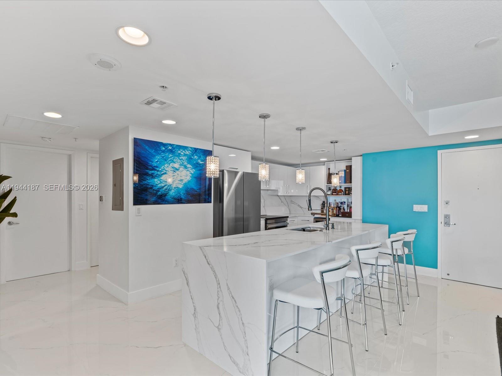 665 Northeast 25th Street, Unit 1101 Miami, FL 33137 - Photo 12 of 47 a large kitchen with a table and chairs