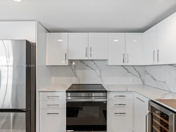 a kitchen that has a sink and a stove in it