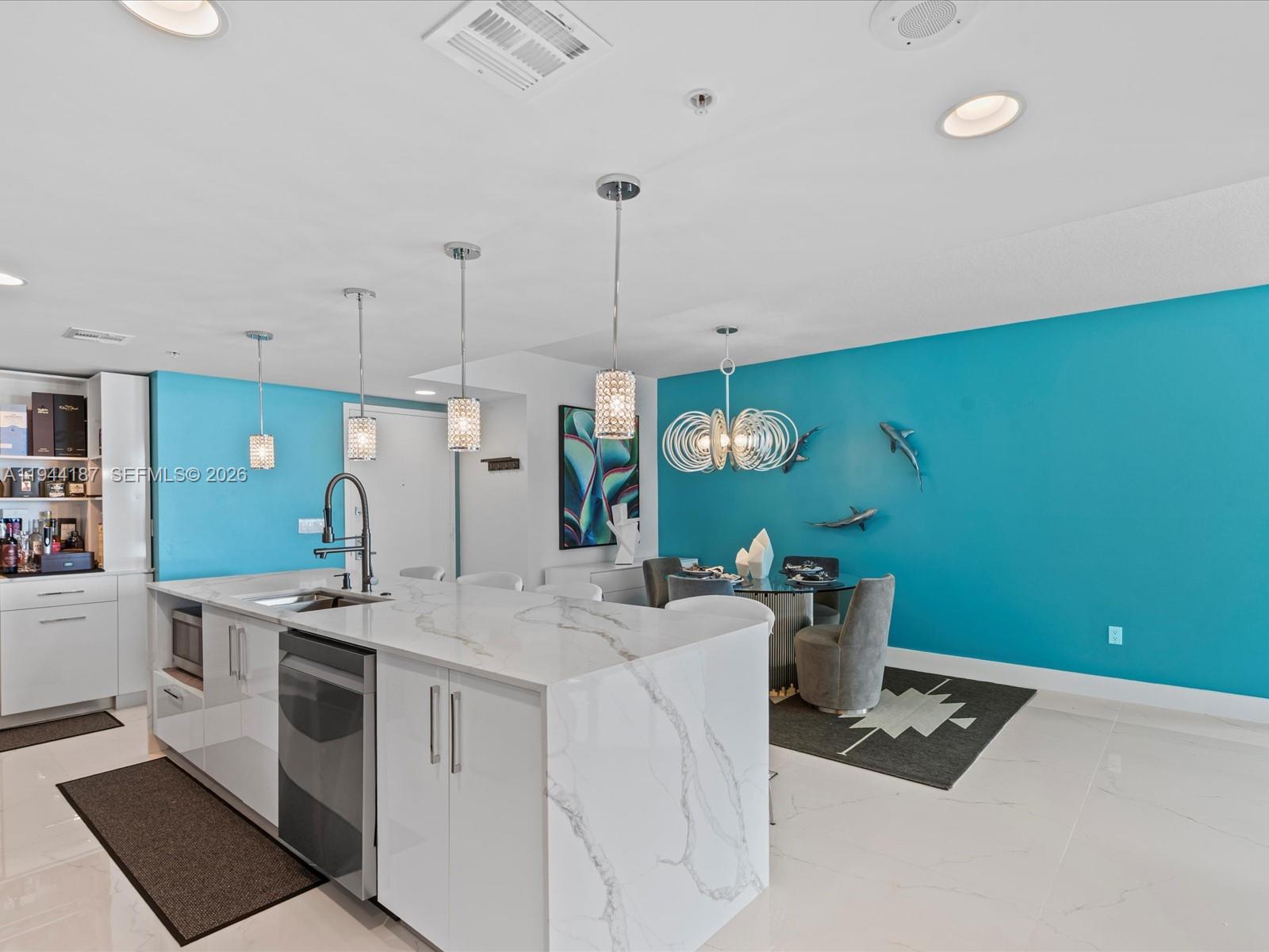 665 Northeast 25th Street, Unit 1101 Miami, FL 33137 - Photo 16 of 47 a kitchen that has a sink and a stove in it