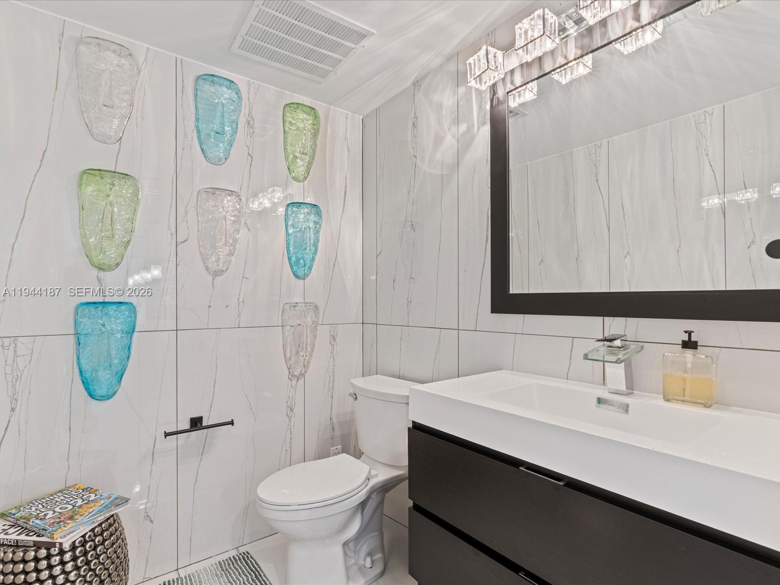 665 Northeast 25th Street, Unit 1101 Miami, FL 33137 - Photo 19 of 47 a bathroom with a sink a toilet and shower