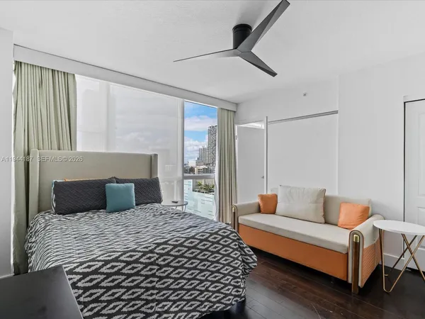 a bedroom with a bed and a painting on the wall