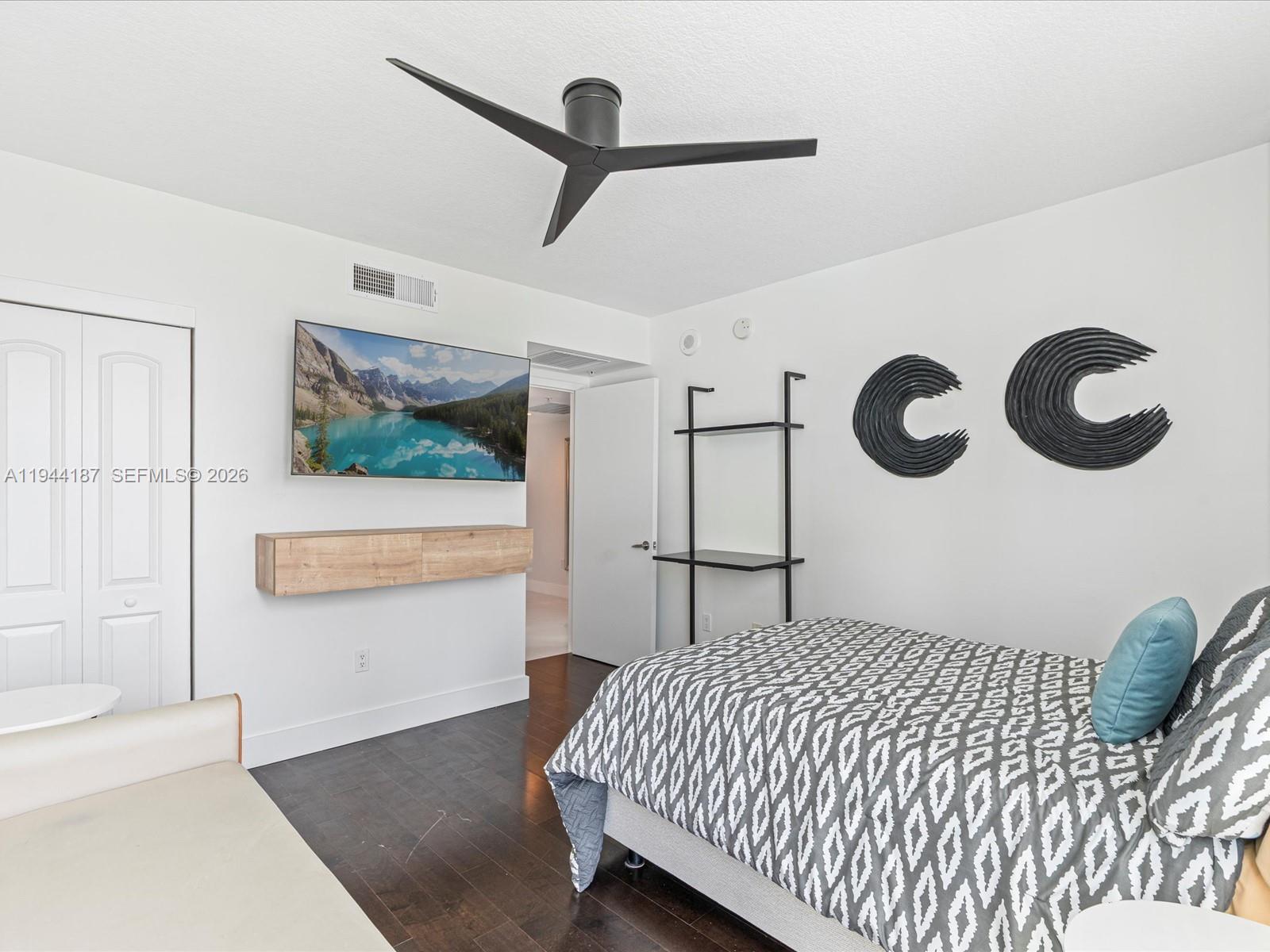 665 Northeast 25th Street, Unit 1101 Miami, FL 33137 - Photo 22 of 47 a bedroom with a bed and a painting on the wall