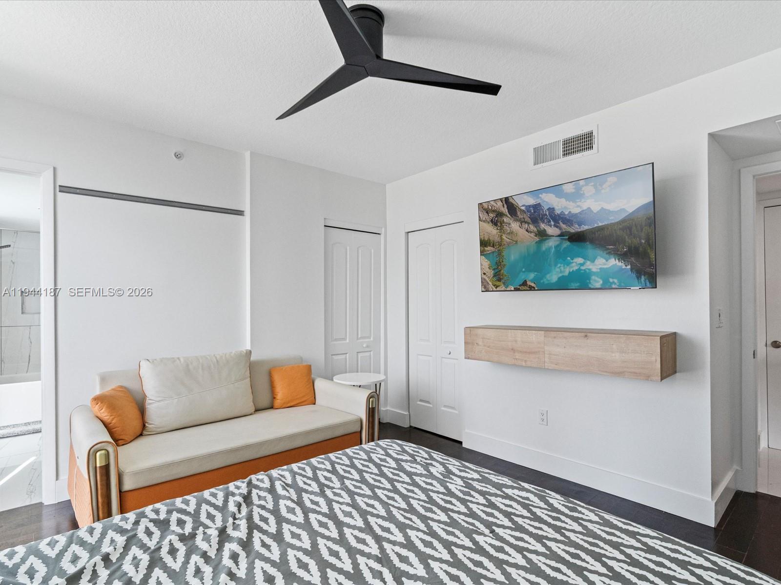 665 Northeast 25th Street, Unit 1101 Miami, FL 33137 - Photo 23 of 47 a living room with furniture and a flat screen tv