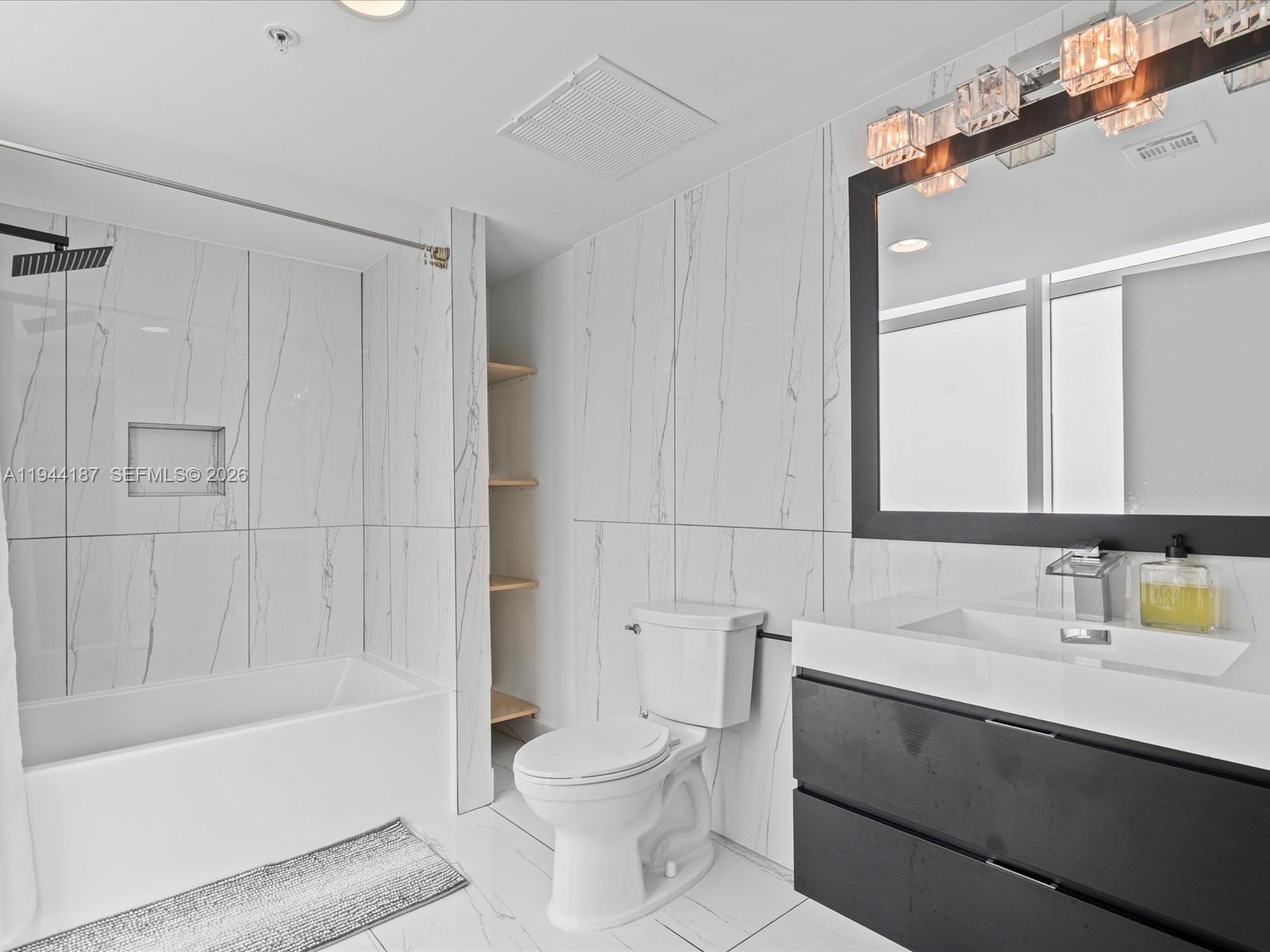 665 Northeast 25th Street, Unit 1101 Miami, FL 33137 - Photo 24 of 47 a bathroom with a sink a toilet and shower