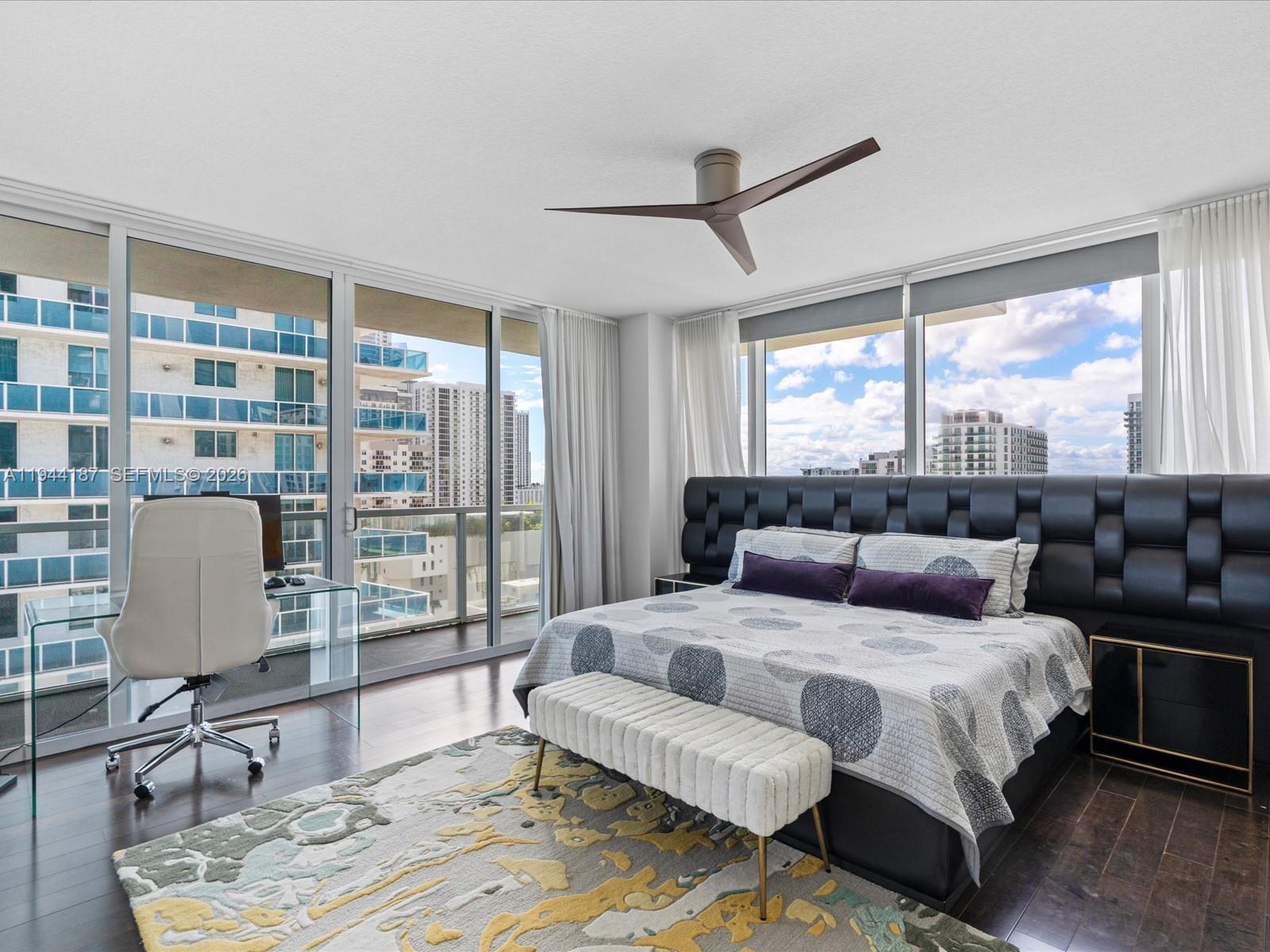 665 Northeast 25th Street, Unit 1101 Miami, FL 33137 - Photo 25 of 47 a bedroom with a large bed and wooden floor