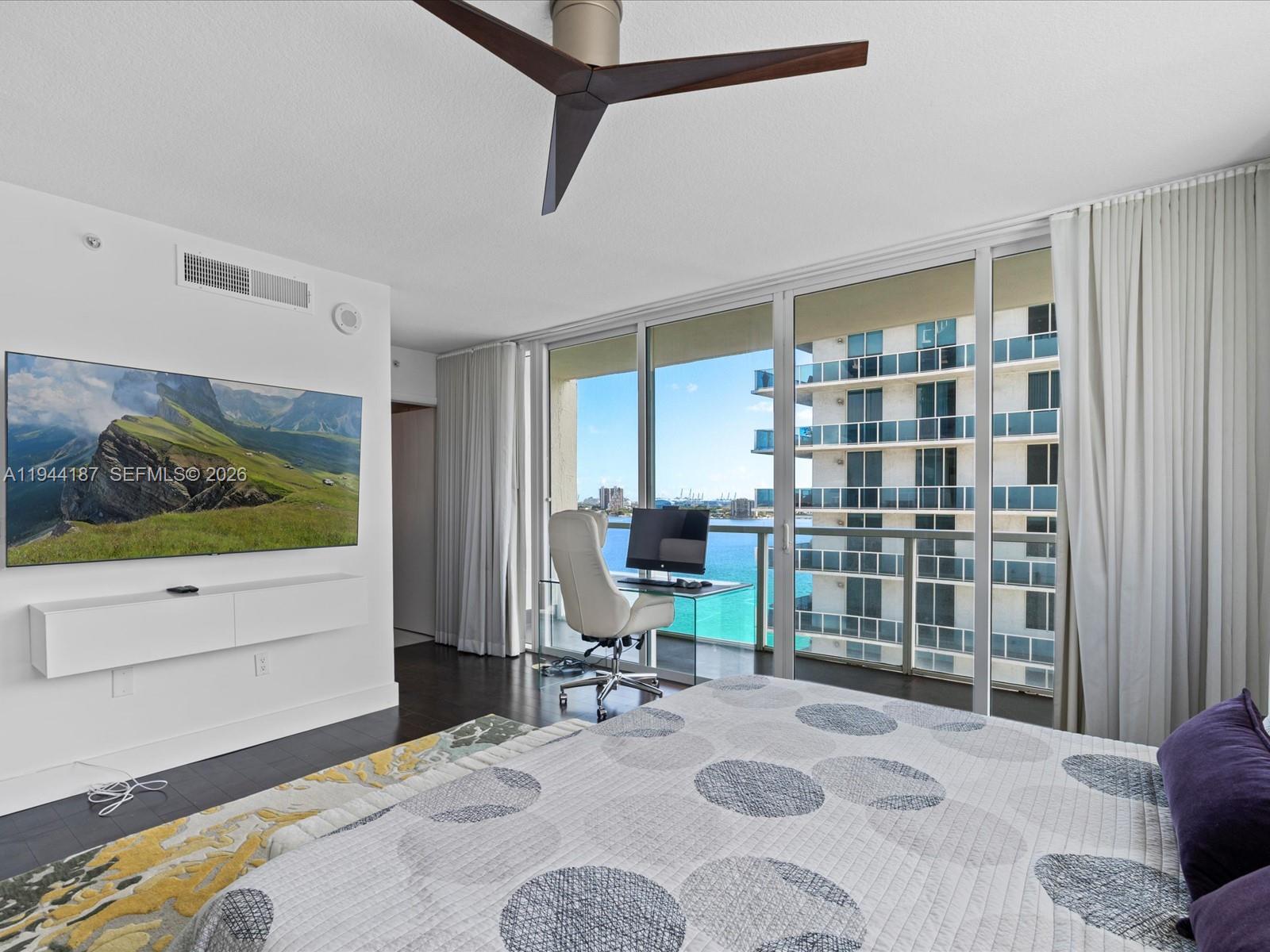 665 Northeast 25th Street, Unit 1101 Miami, FL 33137 - Photo 26 of 47 a bedroom with a bed bookshelf and a window