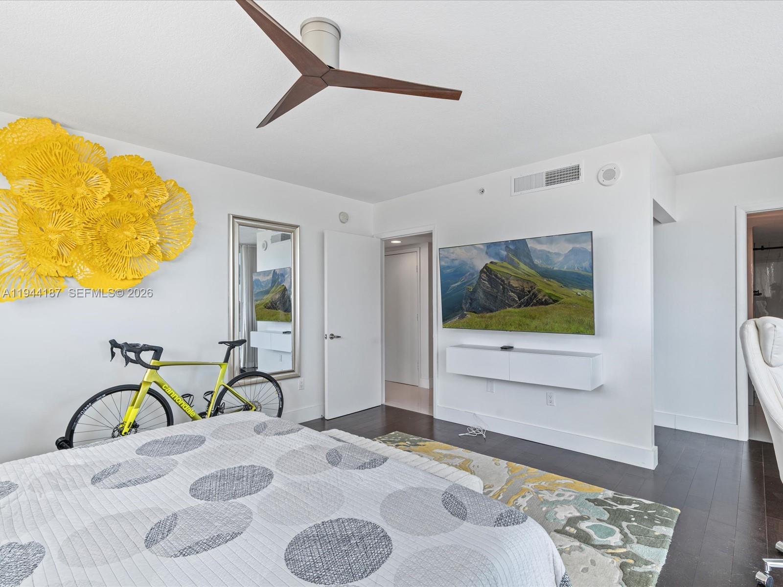 665 Northeast 25th Street, Unit 1101 Miami, FL 33137 - Photo 27 of 47 a bedroom with a bed and wooden floor