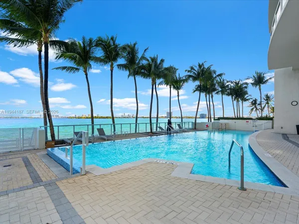 a view of a palm plant from a balcony