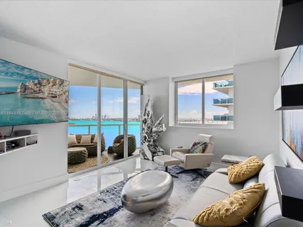 a living room with furniture and a large window