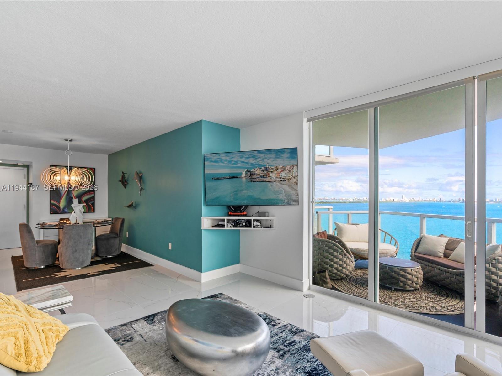 665 Northeast 25th Street, Unit 1101 Miami, FL 33137 - Photo 9 of 47 a living room with furniture and a wooden floor