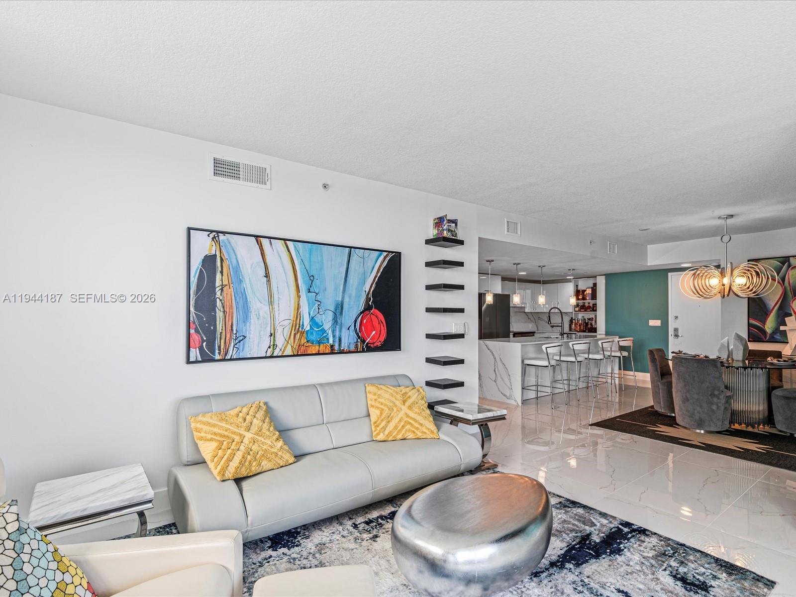 665 Northeast 25th Street, Unit 1101 Miami, FL 33137 - Photo 10 of 47 a living room with furniture and a flat screen tv