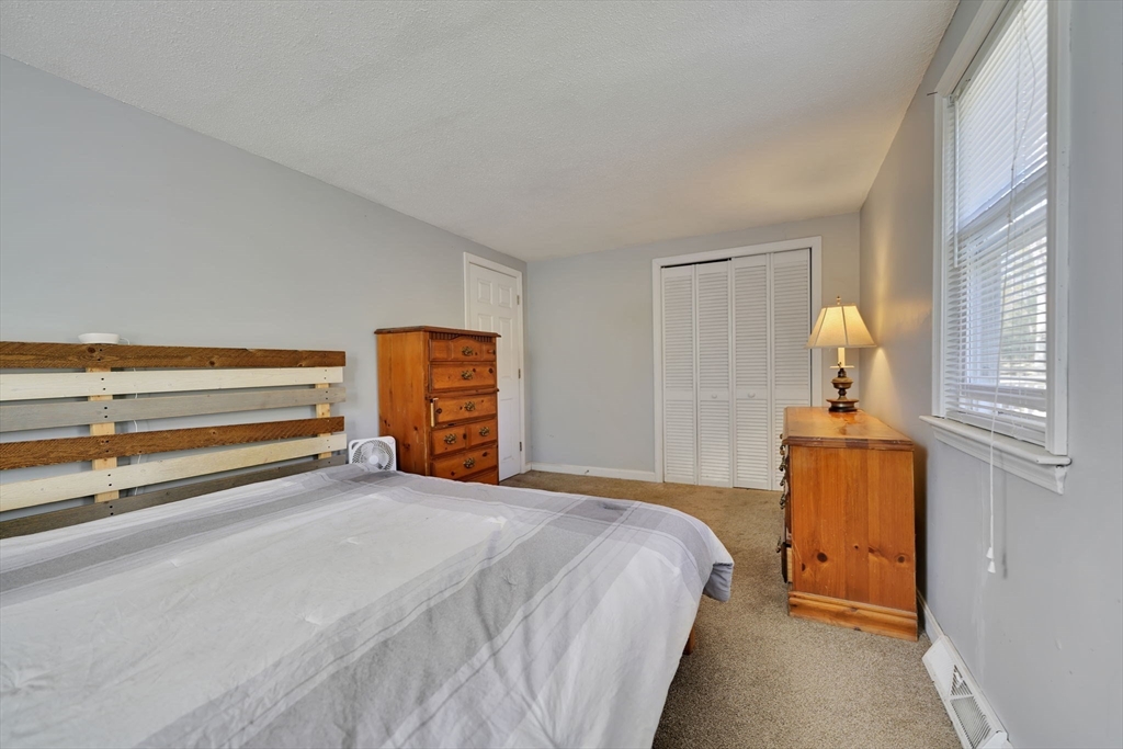 41 Standish Avenue Wareham, MA 02538 - Photo 14 of 35 a bedroom with a bed and wooden floor