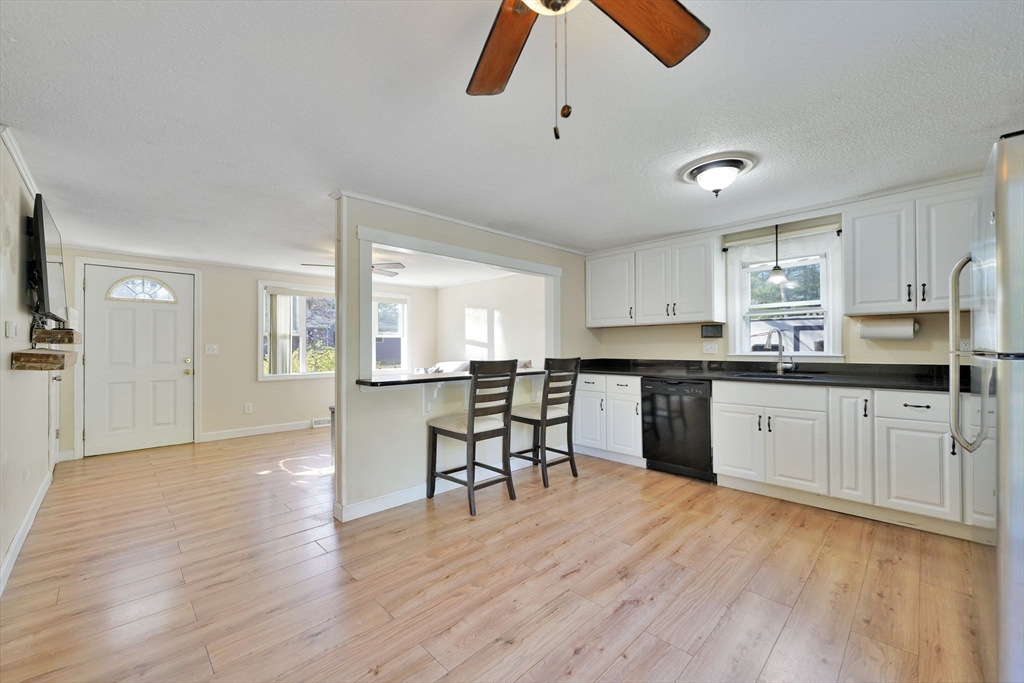 41 Standish Avenue Wareham, MA 02538 - Photo 8 of 35 a kitchen with granite countertop a wooden floor a center island cabinets and appliances