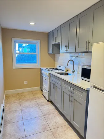 a kitchen with a sink a stove and cabinets
