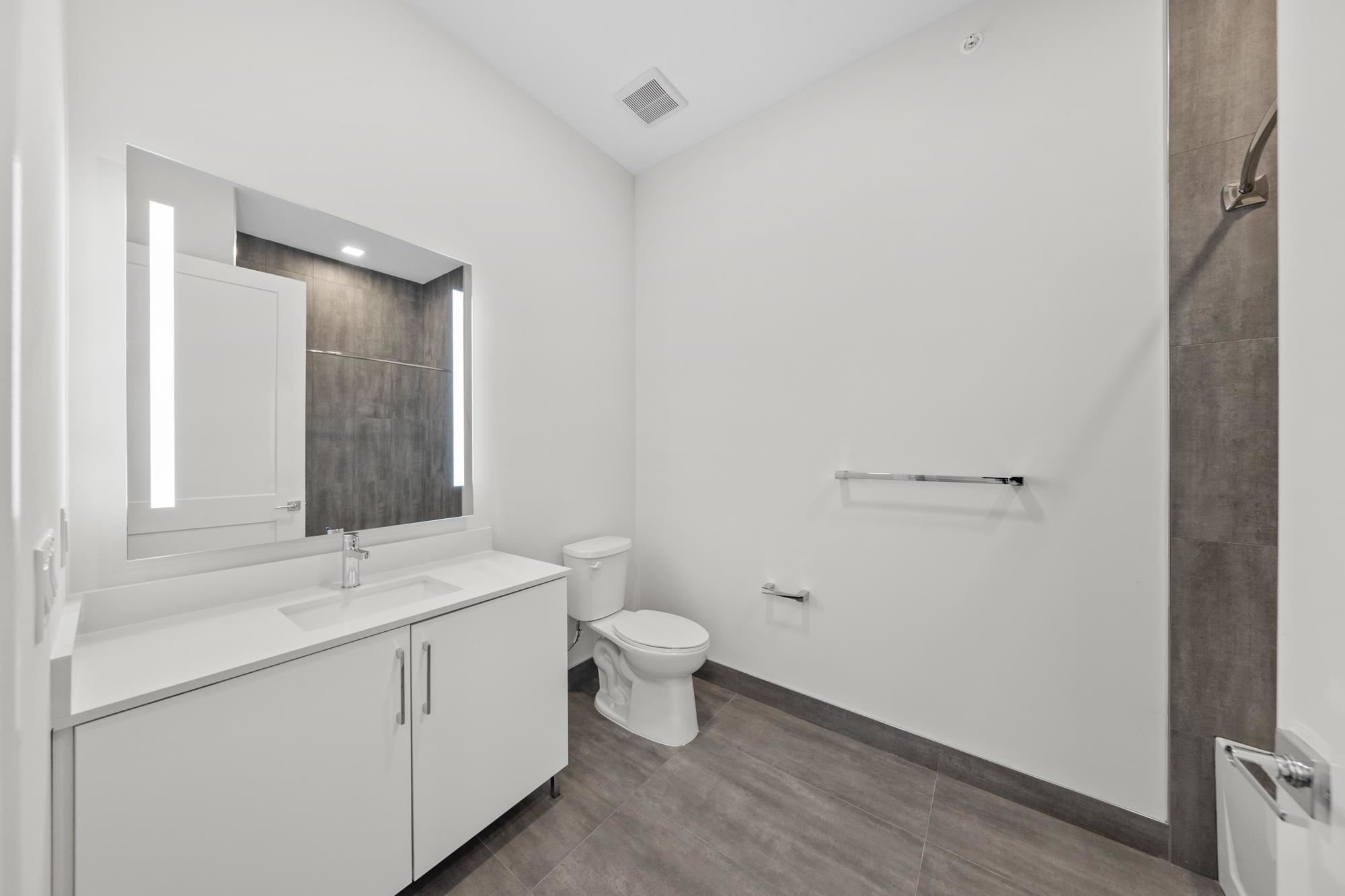 121 34th Street, Unit 401 Union City, NJ 07087 - Photo 12 of 44 a bathroom with a sink a toilet and mirror