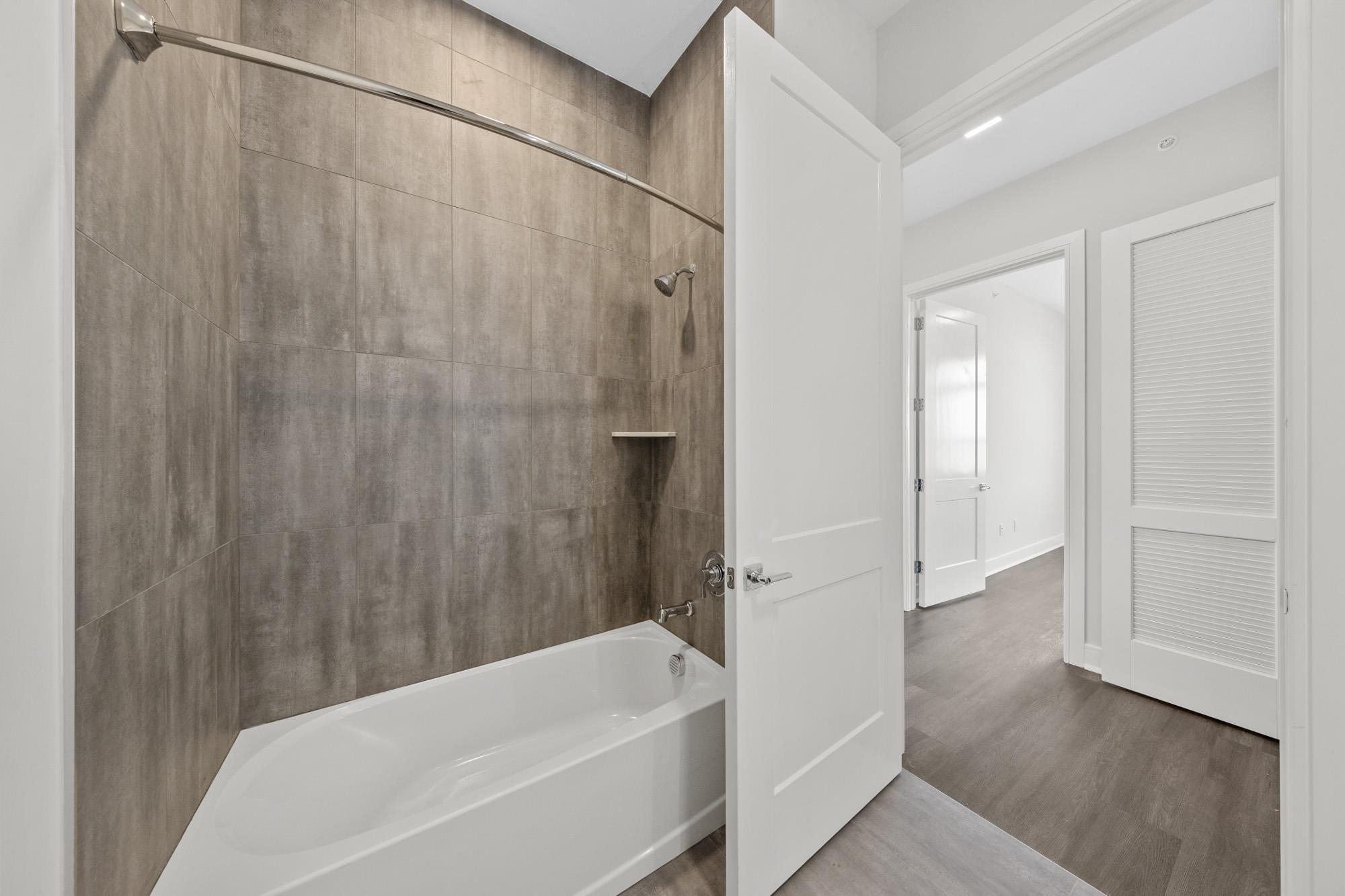 121 34th Street, Unit 401 Union City, NJ 07087 - Photo 13 of 44 a bathroom with a bathtub and a shower