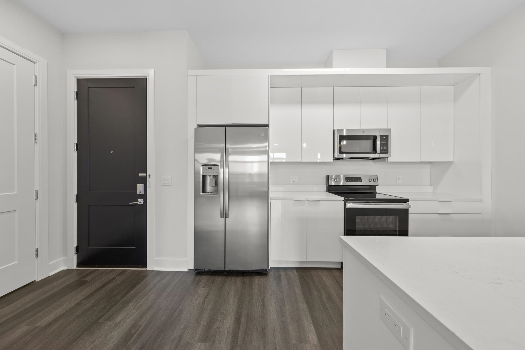 121 34th Street, Unit 401 Union City, NJ 07087 - Photo 2 of 44 a kitchen with kitchen island a refrigerator and a stove top oven