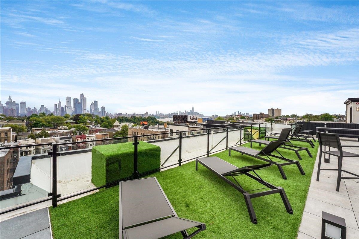 121 34th Street, Unit 401 Union City, NJ 07087 - Photo 28 of 44 a view of a chairs and table in the garden