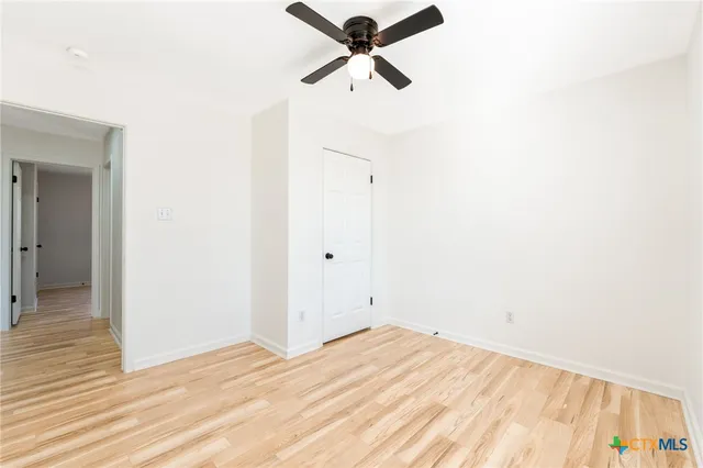 a view of a room with a ceiling fan