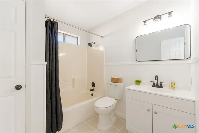 a bathroom with a toilet sink and shower