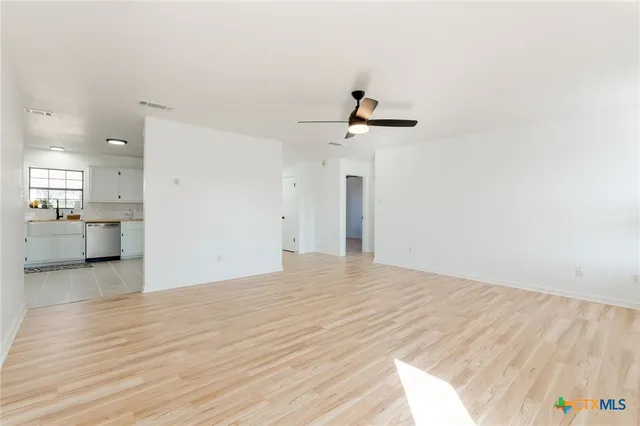 a view of a room with a sink and wooden floor