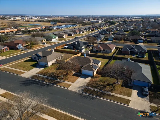an aerial view of residential houses with outdoor space