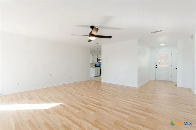 a view of a room with a ceiling fan