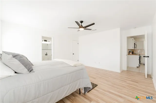 a bedroom with a bed and a chandelier