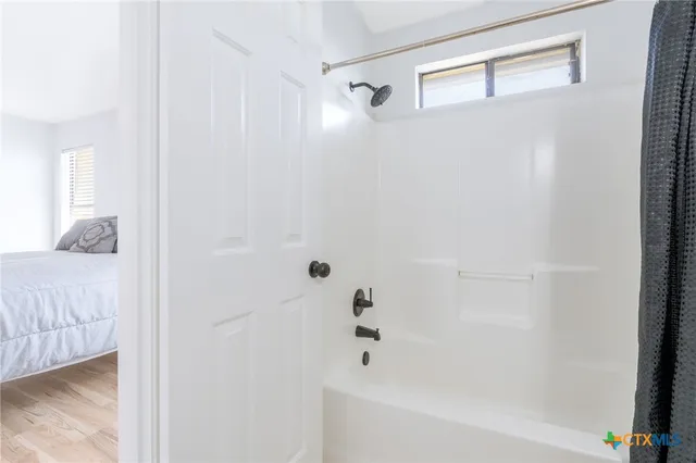 a bathroom with a tub and shower