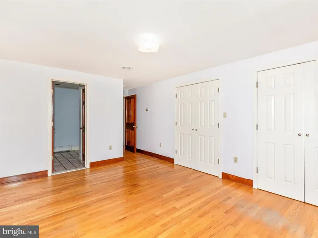 a living room with a couch and wooden floor