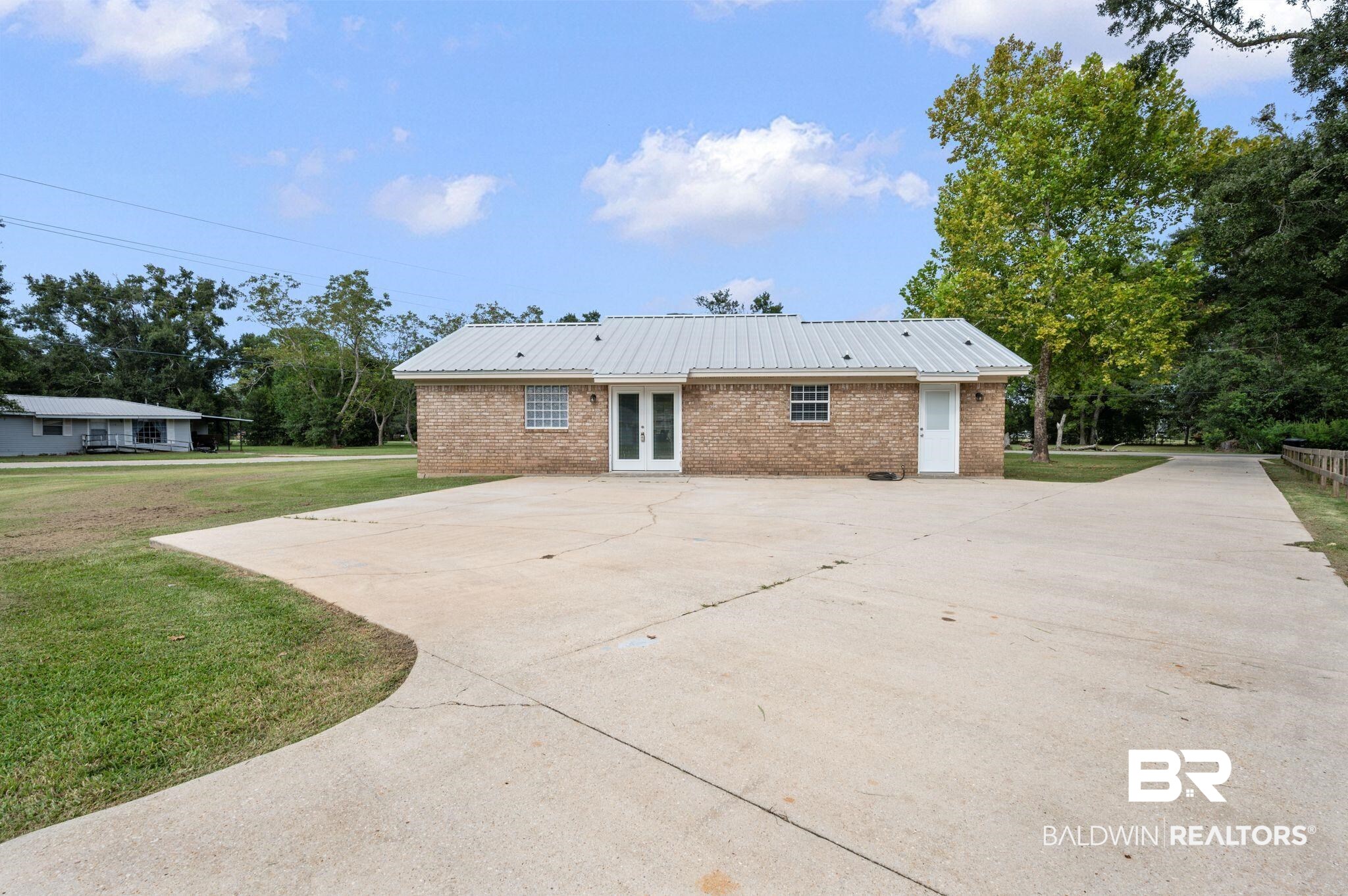 1107 North Oak Street Loxley, AL 36551 - Photo 23 of 40 View of property exterior featuring a yard and a patio
