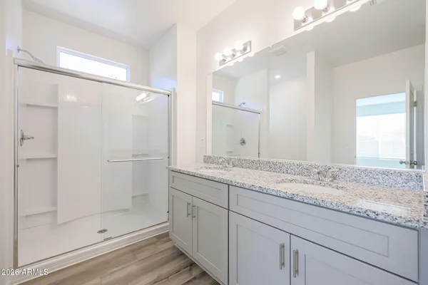 a bathroom with a granite countertop sink mirror and shower